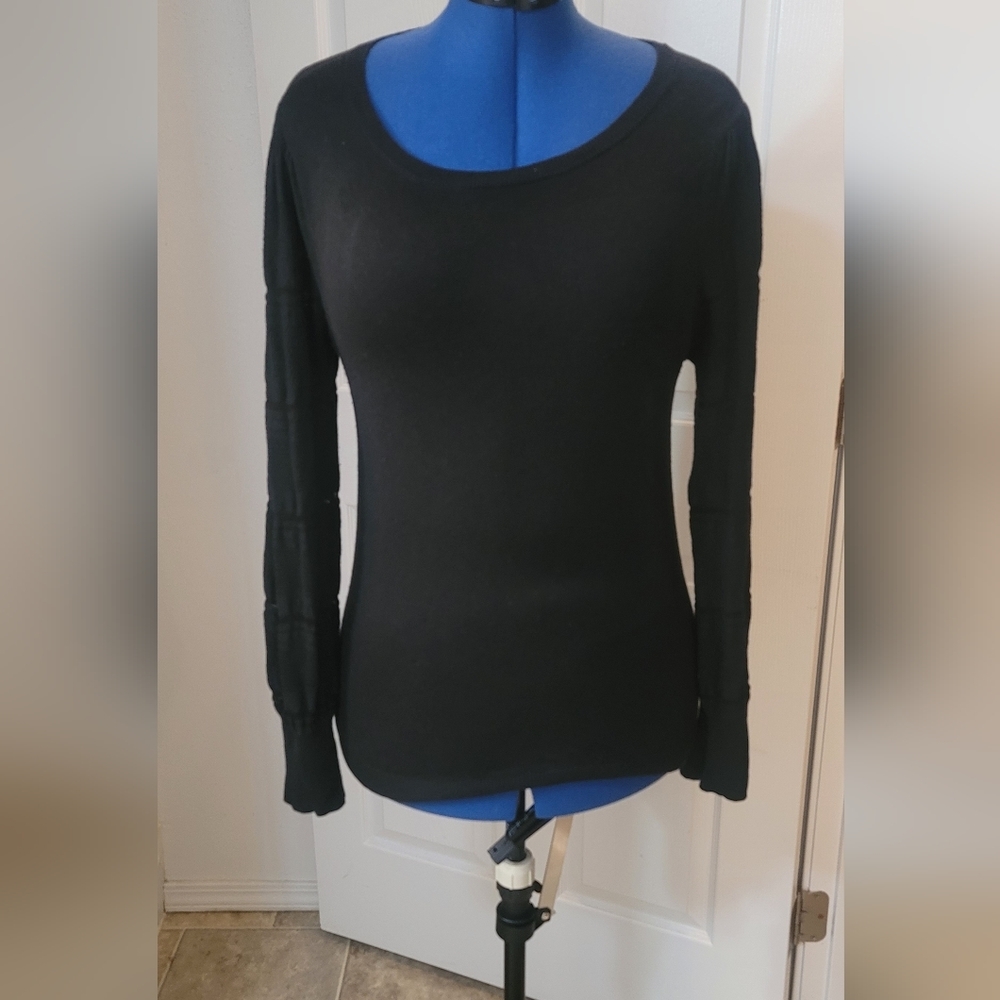 Black sweater with twisted back and lace sleeve detail.